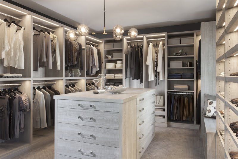 White reach-in closet with drawers and hanging rods