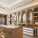 A modern his-and her walk-in closet with a center island and storage for accessories and shoes.